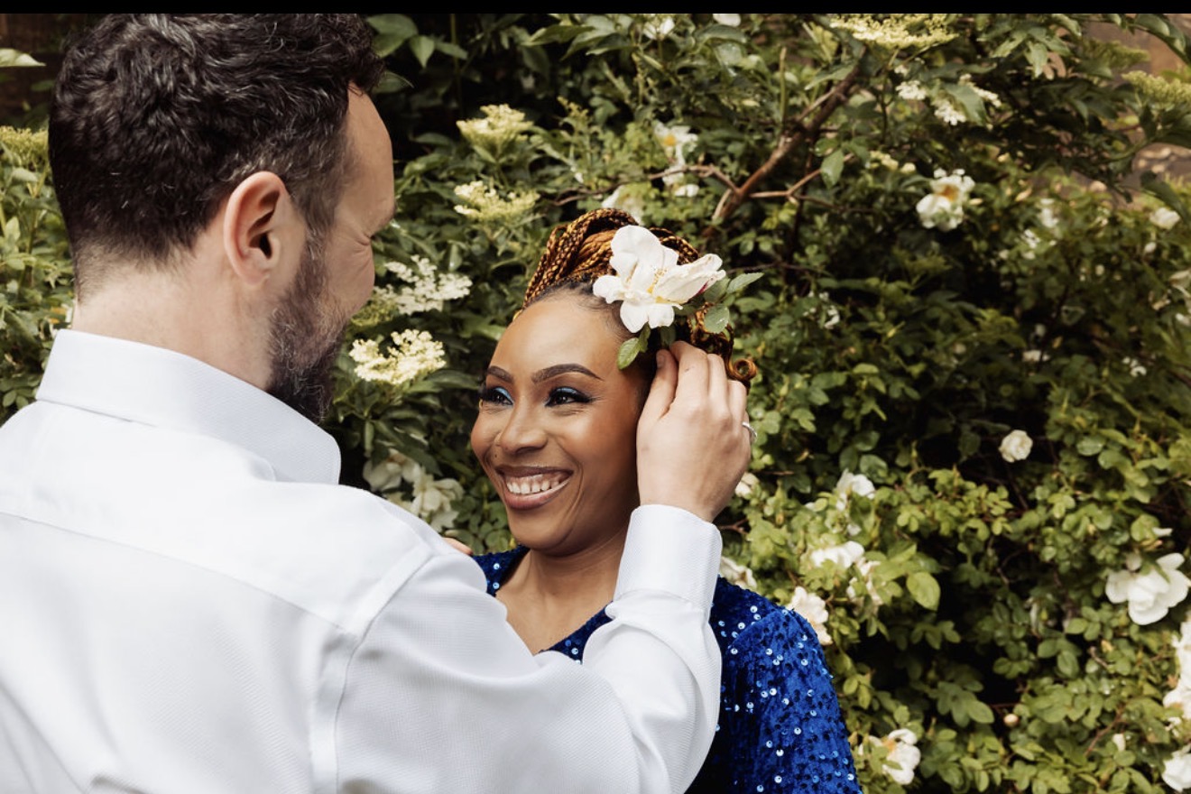Elliott places a white flower in Gabriella’s hair. Photograph: Thomasxphotography